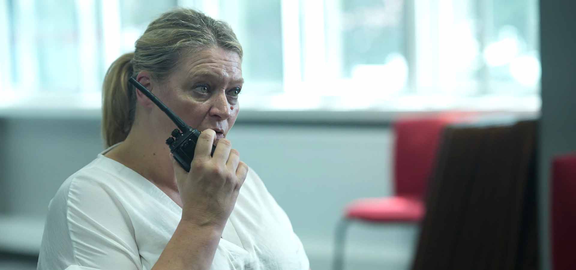 A female candidate getting training on how to effectively use communication gadgets.